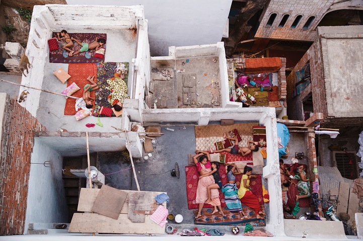 I arrived at my guest house in Varanasi at 5:30am, I instinctively climbed the 7 sets of stairs to the rooftop (which happened to be the highest in the vicinity) to see the sunrise over the famous Ganges River. As the sun was rising I looked over the right hand side of the balcony and my jaw dropped with disbelief. Below were families - mothers, fathers, children, brothers, sister and dogs all sleeping on the top of their houses. It was mid summer in Varanasi and sleeping sans AC was difficult.